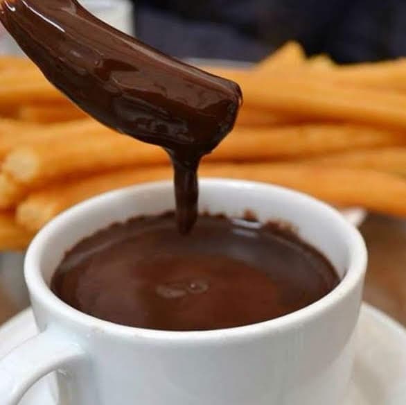 A delicious plate of churros with a cup of hot chocolate
